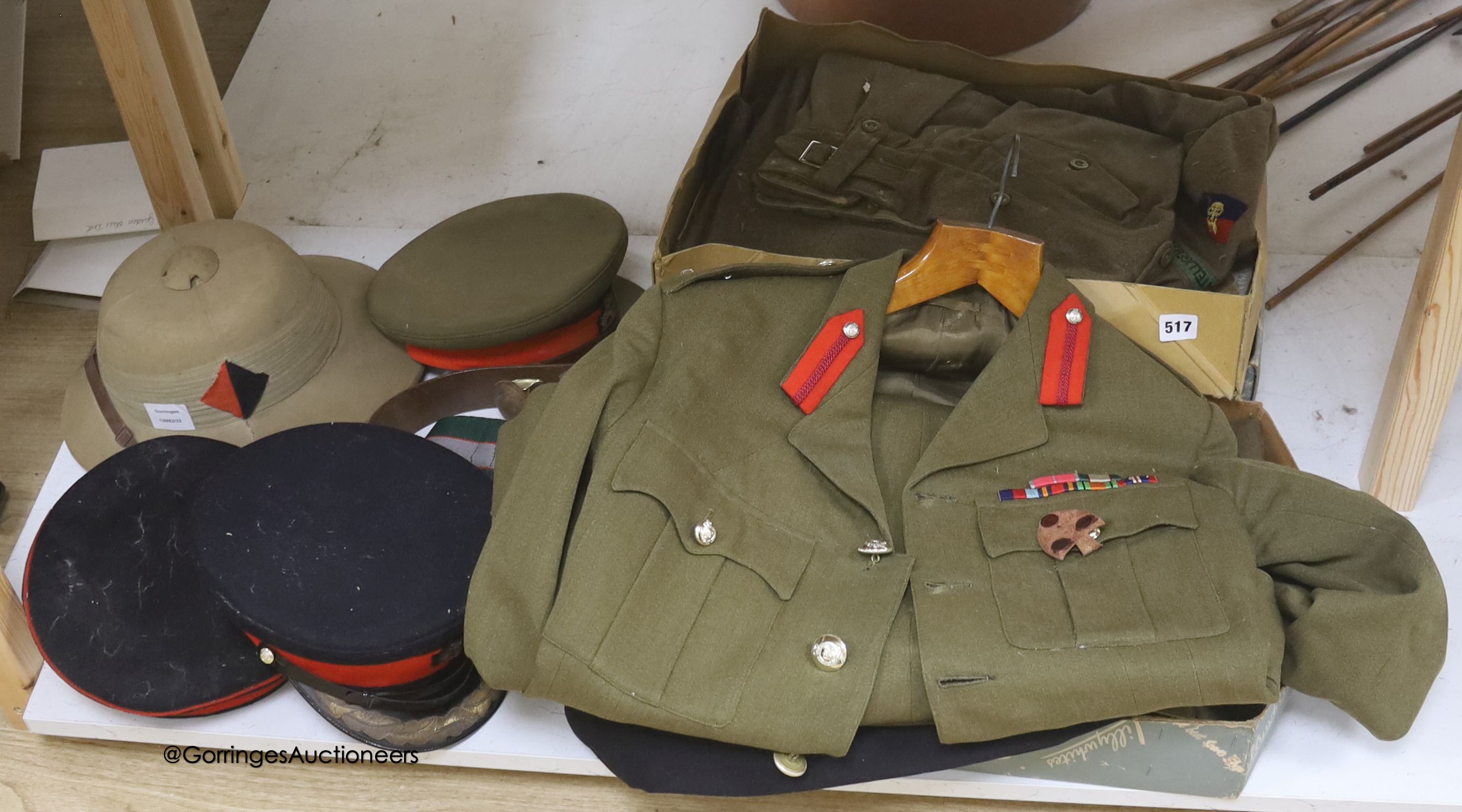 An R.A. cap, dress jacket, pith helmet and SRN uniform